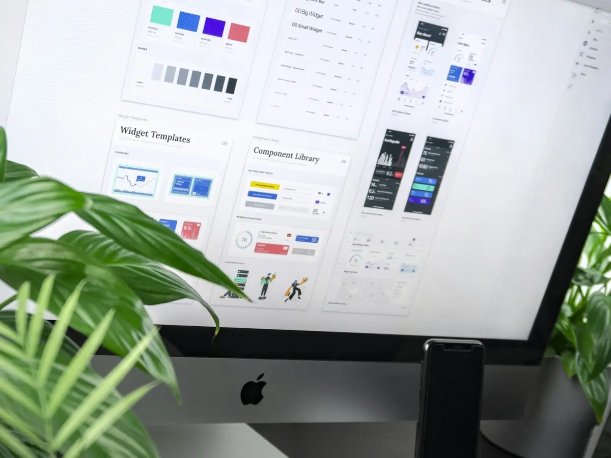 A design system laid out on a studio monitor, components and colour tokens on screen.